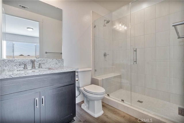 1734 Lester Ave, Clovis, CA 93619 - bathroom featuring wood finished floors, a stall shower, vanity, and toilet