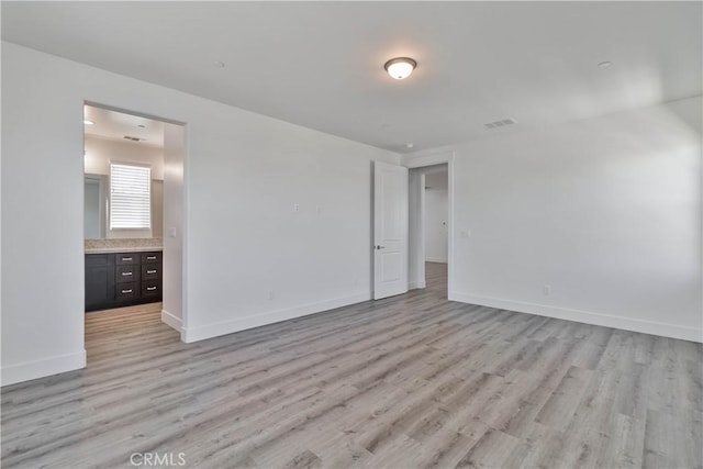 1734 Lester Ave, Clovis, CA 93619 - spare room with light wood-style floors and baseboards