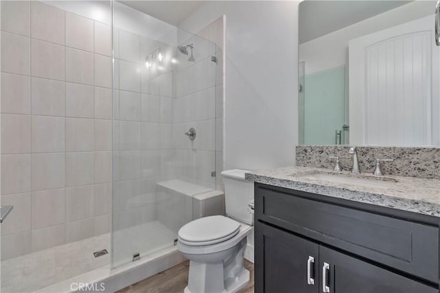 1734 Lester Ave, Clovis, CA 93619 - bathroom with vanity, toilet, a tile shower, and wood finished floors