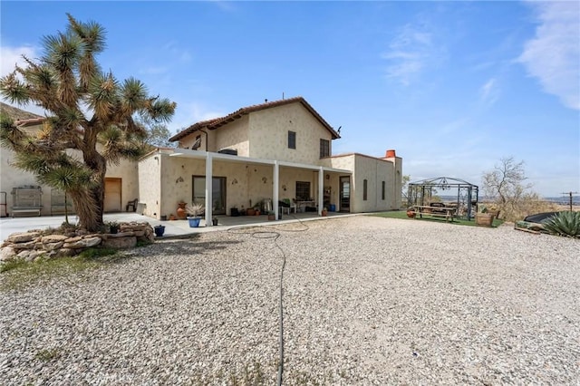 9075 Mesa Vista St, Apple Valley, CA 92308 - back of property with stucco siding and a patio