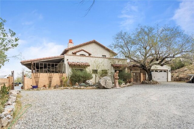 9075 Mesa Vista St, Apple Valley, CA 92308 - mediterranean / spanish house with a garage, driveway, a chimney, and stucco siding