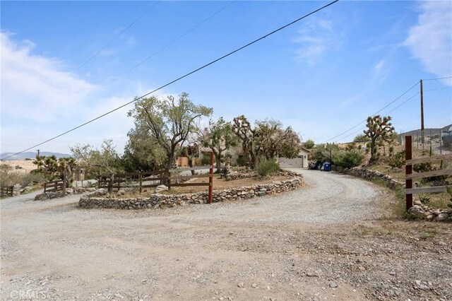 9075 Mesa Vista St, Apple Valley, CA 92308 - view of yard with a garage and dirt driveway