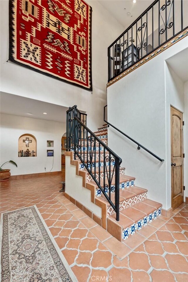 9075 Mesa Vista St, Apple Valley, CA 92308 - stairs with a high ceiling, arched walkways, baseboards, and recessed lighting