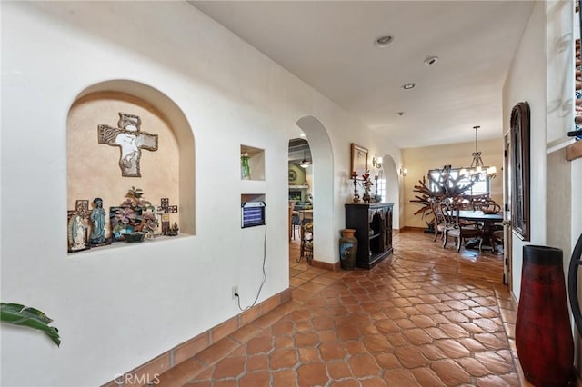 9075 Mesa Vista St, Apple Valley, CA 92308 - hallway featuring arched walkways, a chandelier, recessed lighting, tile patterned flooring, and baseboards
