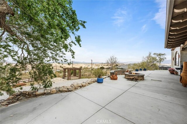 9075 Mesa Vista St, Apple Valley, CA 92308 - view of patio featuring an outdoor fire pit