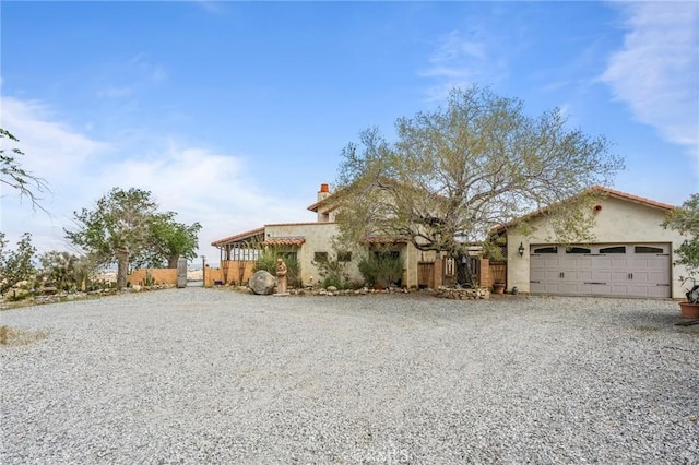 9075 Mesa Vista St, Apple Valley, CA 92308 - view of front of home featuring driveway, an attached garage, stucco siding, and a chimney