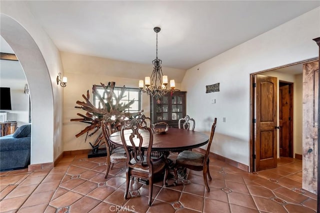 9075 Mesa Vista St, Apple Valley, CA 92308 - tiled dining area featuring arched walkways, a chandelier, and baseboards
