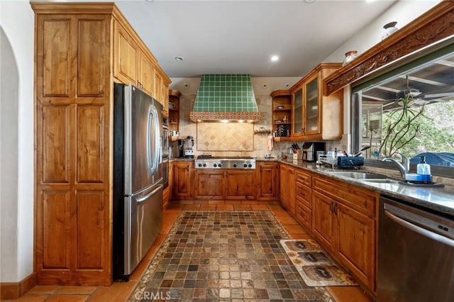 9075 Mesa Vista St, Apple Valley, CA 92308 - kitchen with appliances with stainless steel finishes, a sink, brown cabinetry, arched walkways, and recessed lighting