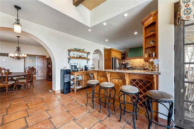 9075 Mesa Vista St, Apple Valley, CA 92308 - kitchen featuring open shelves, freestanding refrigerator, arched walkways, tasteful backsplash, and recessed lighting