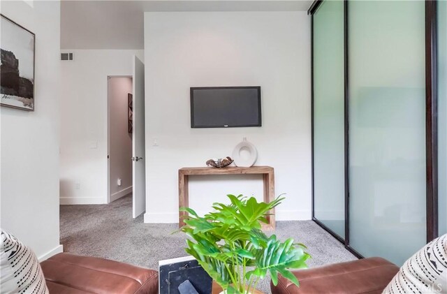 395 E 4th St Unit 13, Long Beach, CA 90802 - carpeted living area featuring baseboards