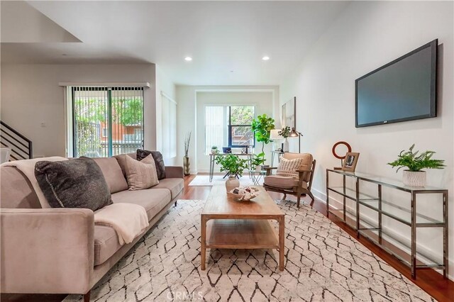 395 E 4th St Unit 13, Long Beach, CA 90802 - living room featuring recessed lighting, wood finished floors, stairs, and baseboards