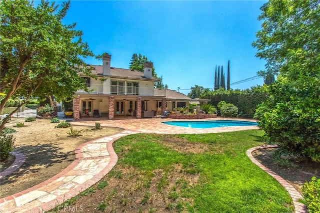 639 Valley View Dr, Redlands, CA 92373 - back of house featuring french doors, a patio area, a yard, and a chimney