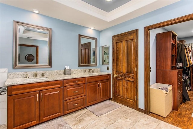639 Valley View Dr, Redlands, CA 92373 - bathroom with double vanity, a walk in closet, and ornamental molding