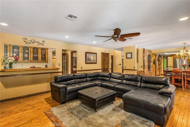 639 Valley View Dr, Redlands, CA 92373 - living room featuring light wood finished floors, a ceiling fan, a chandelier, recessed lighting, and bar area