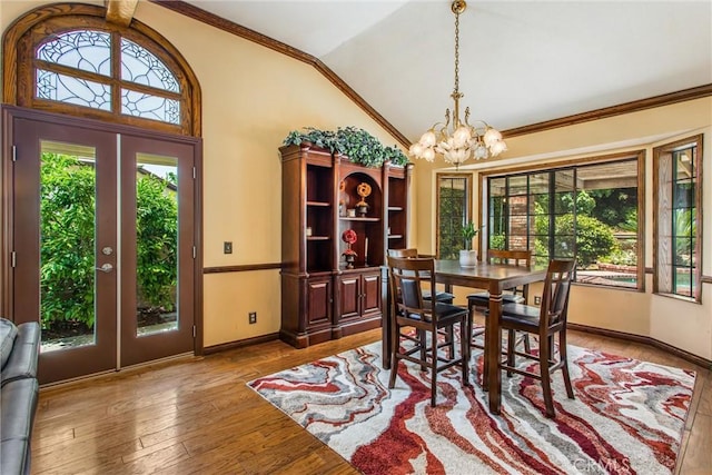 639 Valley View Dr, Redlands, CA 92373 - dining room featuring a chandelier, vaulted ceiling, healthy amount of natural light, baseboards, and hardwood / wood-style floors