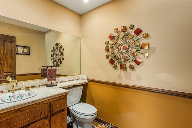 639 Valley View Dr, Redlands, CA 92373 - bathroom featuring toilet, vanity, and decorative backsplash