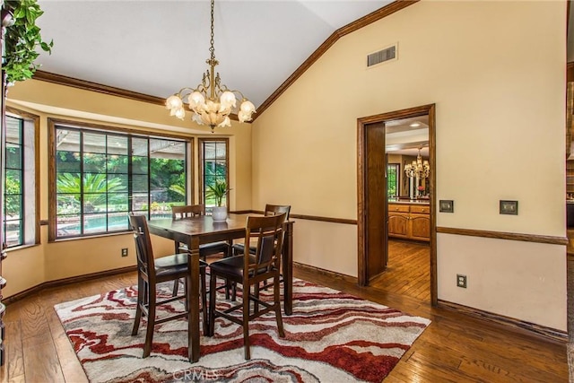 639 Valley View Dr, Redlands, CA 92373 - dining space featuring a chandelier, crown molding, vaulted ceiling, wood-type flooring, and baseboards