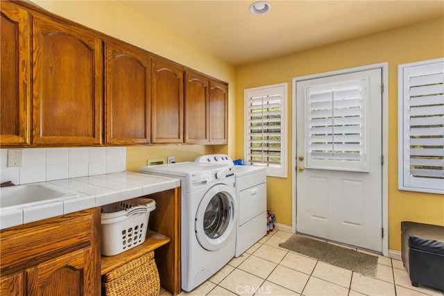 639 Valley View Dr, Redlands, CA 92373 - laundry room featuring cabinet space, washing machine and clothes dryer, light tile patterned flooring, and baseboards