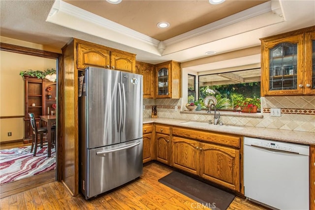 639 Valley View Dr, Redlands, CA 92373 - kitchen with freestanding refrigerator, dishwasher, a raised ceiling, a sink, and ornamental molding
