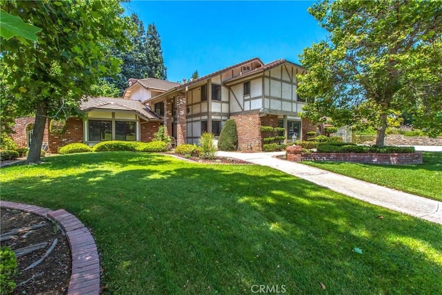 639 Valley View Dr, Redlands, CA 92373 - view of front of property with a front lawn, brick siding, stucco siding, and a tile roof