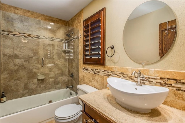 639 Valley View Dr, Redlands, CA 92373 - bathroom featuring tile walls, shower / bath combination with glass door, vanity, and toilet