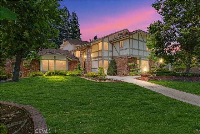 639 Valley View Dr, Redlands, CA 92373 - view of front of property featuring a front lawn, brick siding, and a tiled roof
