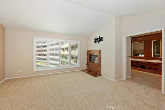 7000 Fabriano Pl, Rancho Cucamonga, CA 91701 - unfurnished living room with carpet floors, a high end fireplace, baseboards, and lofted ceiling