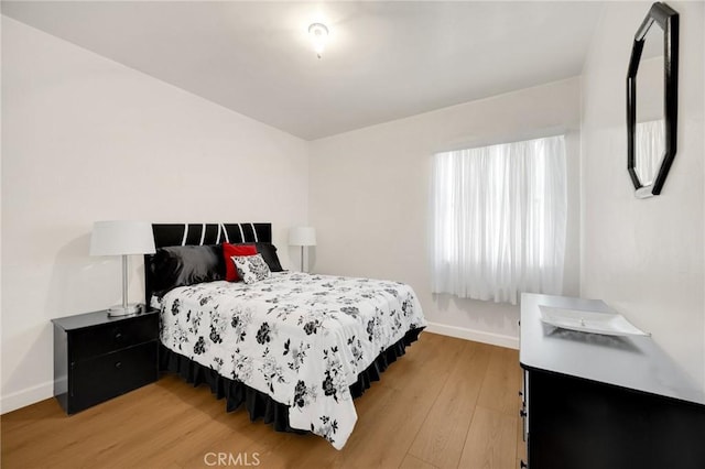 11705 Adonis Ave, Norwalk, CA 90650 - bedroom featuring baseboards and light wood-type flooring