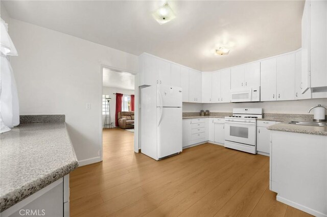 11705 Adonis Ave, Norwalk, CA 90650 - kitchen featuring white appliances, light wood-style flooring, light countertops, and white cabinetry