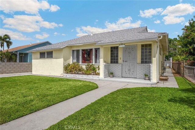 11705 Adonis Ave, Norwalk, CA 90650 - view of front of property with roof with shingles, brick siding, and stucco siding