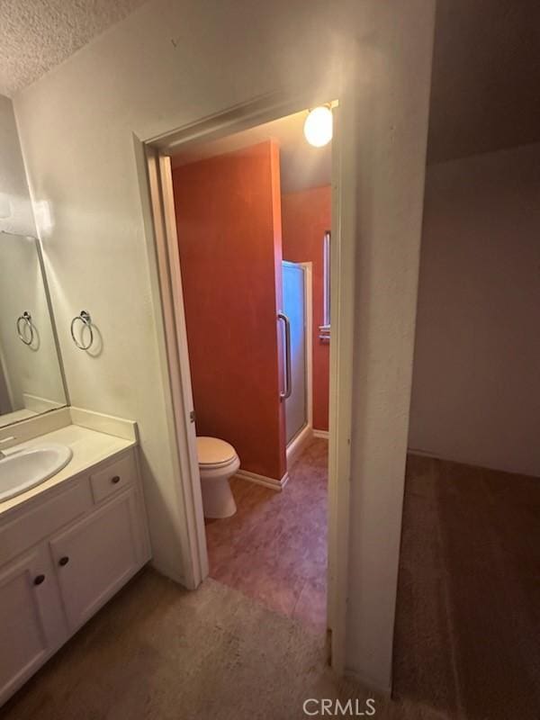 869 El Portal Dr, Merced, CA 95340 - full bathroom with toilet, vanity, and a textured ceiling