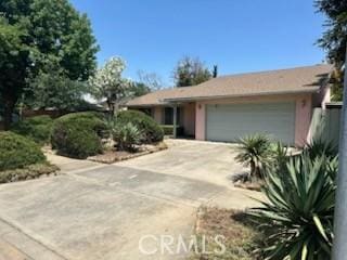869 El Portal Dr, Merced, CA 95340 - view of front of house featuring an attached garage and driveway