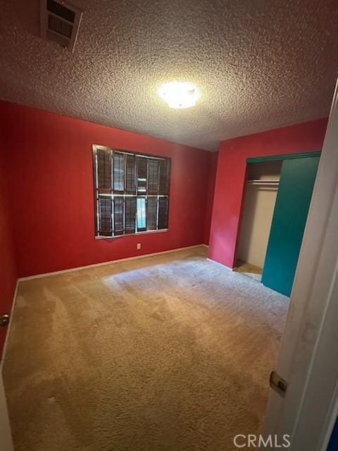869 El Portal Dr, Merced, CA 95340 - unfurnished bedroom with carpet flooring, a closet, and a textured ceiling
