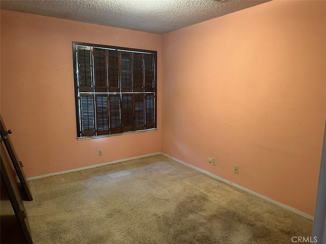 869 El Portal Dr, Merced, CA 95340 - empty room with carpet flooring, a textured ceiling, and baseboards