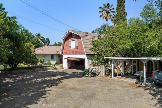 5426 Lakeview Ave, Yorba Linda, CA 92886 - colonial inspired home with a gambrel roof, a garage, and dirt driveway
