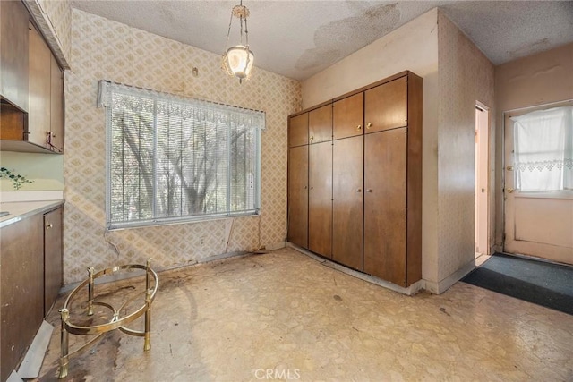 5426 Lakeview Ave, Yorba Linda, CA 92886 - unfurnished bedroom with a textured ceiling, a closet, light floors, and wallpapered walls