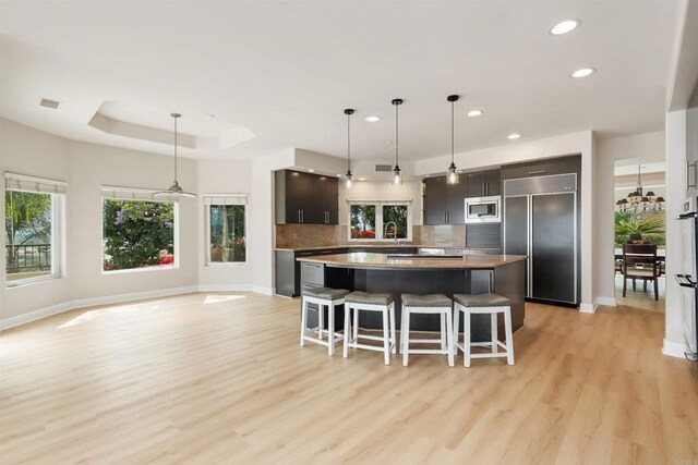 1320 Sleeping Indian Rd, Oceanside, CA 92057 - kitchen featuring built in appliances, a center island, recessed lighting, baseboards, and a kitchen breakfast bar