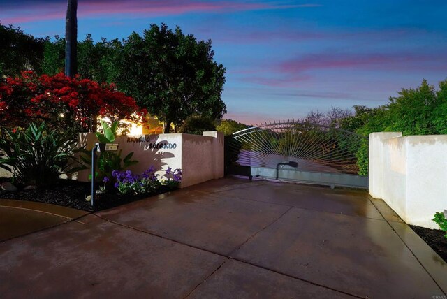 1320 Sleeping Indian Rd, Oceanside, CA 92057 - patio terrace at dusk with a gate