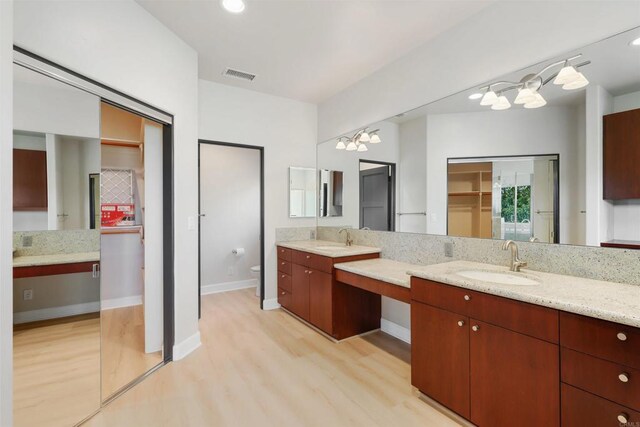 1320 Sleeping Indian Rd, Oceanside, CA 92057 - bathroom with wood finished floors, vanity, a chandelier, toilet, and a closet