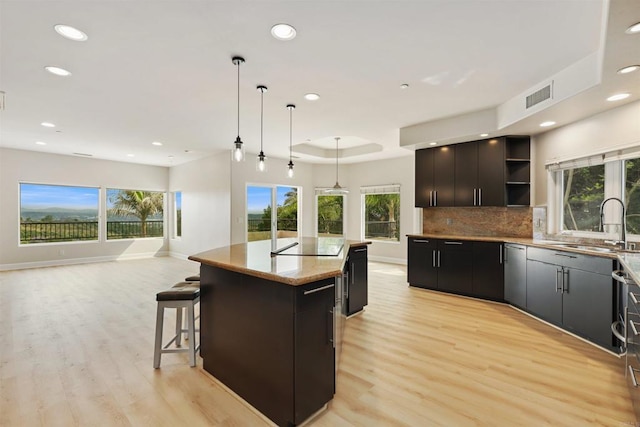 1320 Sleeping Indian Rd, Oceanside, CA 92057 - kitchen featuring open shelves, a kitchen island, recessed lighting, a sink, and open floor plan