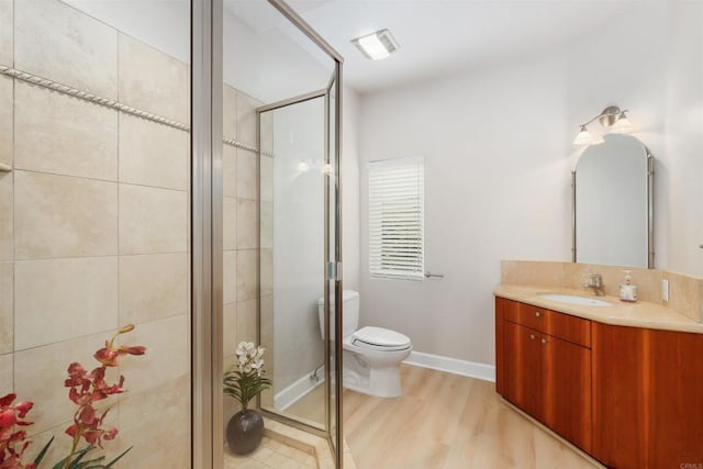 1320 Sleeping Indian Rd, Oceanside, CA 92057 - full bathroom featuring vanity, toilet, a stall shower, and wood finished floors