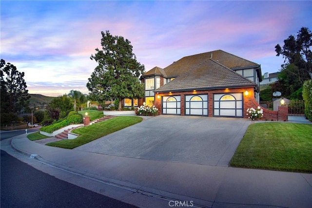 29302 Laro Dr, Agoura Hills, CA 91301 - english style home featuring driveway, an attached garage, a tiled roof, and brick siding