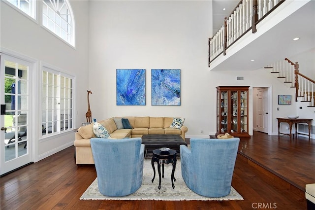 29302 Laro Dr, Agoura Hills, CA 91301 - living room featuring a towering ceiling, stairway, hardwood / wood-style floors, and baseboards