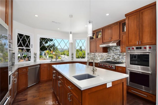 29302 Laro Dr, Agoura Hills, CA 91301 - kitchen featuring a sink, stainless steel appliances, under cabinet range hood, light countertops, and dark wood-style flooring