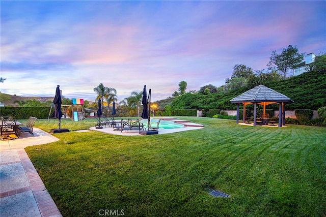 29302 Laro Dr, Agoura Hills, CA 91301 - yard at dusk featuring a gazebo, a patio, a lawn, and an outdoor pool