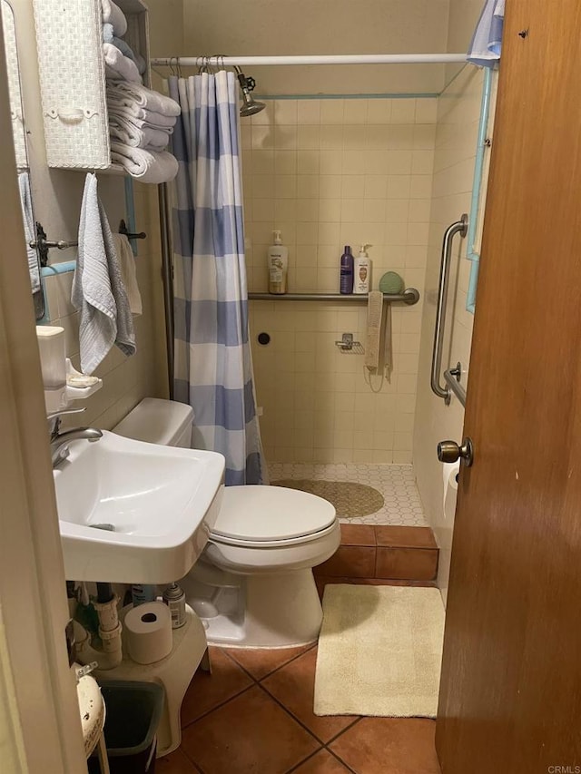 722 N Preston Dr E, Calexico, CA 92231 - full bathroom featuring a shower stall, tile patterned floors, toilet, and a sink