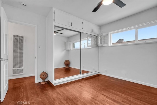 601 Olive Ave Unit L, Long Beach, CA 90802 - unfurnished bedroom with a heating unit, wood finished floors, baseboards, ceiling fan, and a closet
