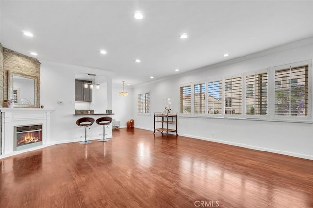601 Olive Ave Unit L, Long Beach, CA 90802 - living room with ornamental molding, wood finished floors, recessed lighting, baseboards, and a glass covered fireplace