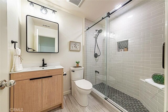 15405 Ashley Ct, Whittier, CA 90603 - full bath featuring vanity, toilet, a shower stall, and wood finished floors