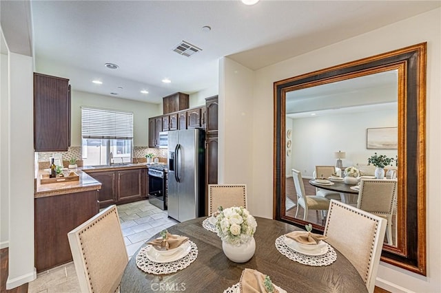 15405 Ashley Ct, Whittier, CA 90603 - kitchen with stainless steel appliances, a sink, dark brown cabinetry, tasteful backsplash, and recessed lighting